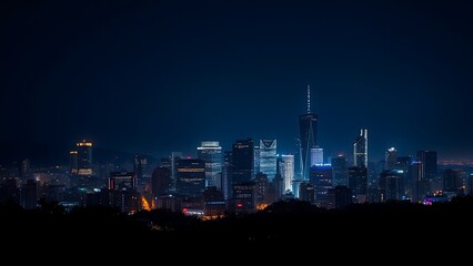 Fototapeta premium A city skyline illuminated at night with long exposure and deep blue tones.