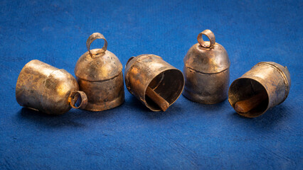 Handmade vintage indian tin bells on blue art paper © MarekPhotoDesign.com