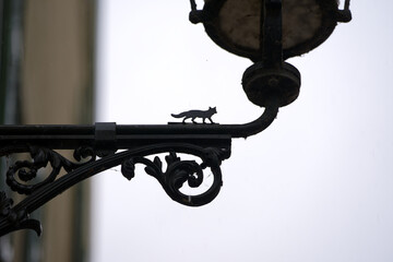 Close-up of traditional street light with wrought iron ornaments and fox at the medieval old town...