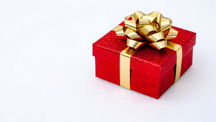 Vibrant red gift box with gold ribbon and bow celebration present festive occasion surprise