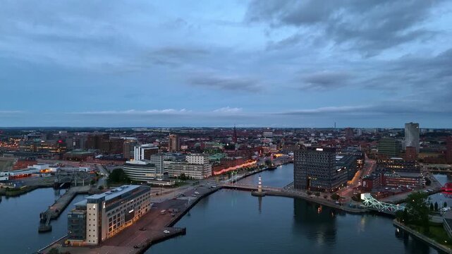 Sunset light dances on modern architecture by the Swedish coast