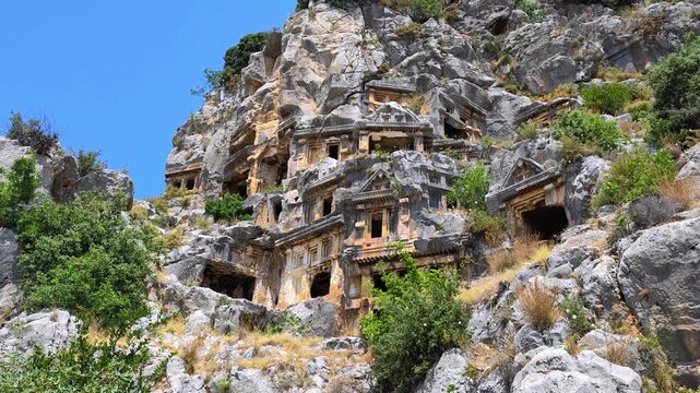 Rock-cut tombs of the ancient Lycian necropolis. Myra is an antique town in Lycia where the small town of Kale (Demre) Turkey. Close-up of rock cut tomb grave. 