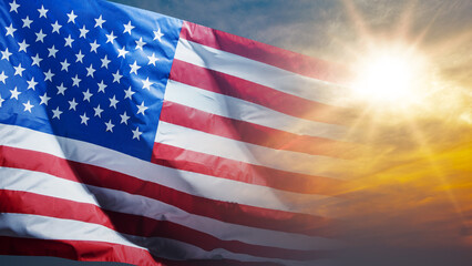 Closeup view of the American flag waving with sunlight background. Copy space. American holiday...