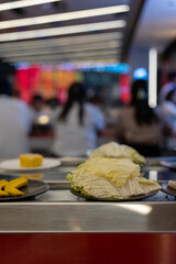 Napa Cabbage on Plate at Shabu-Shabu Conveyor Belt Restaurant