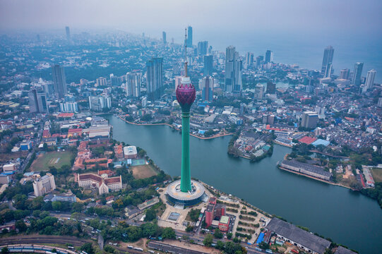 Aerial view of the Lotus Tower rising majestically above the cityscape, its vibrant green stem contrasting with the muted tones of the surrounding buildings, Colombo, Western Province, Sri Lanka.