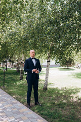Portrait of a young groom in a blue suit