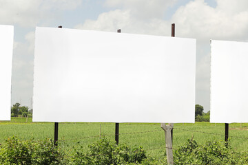 in india. billboard on city road, outdoor advertising, mockup billing board in front of green tree and Blank white background for branding design large hoarding, Outdoor advertising construction.