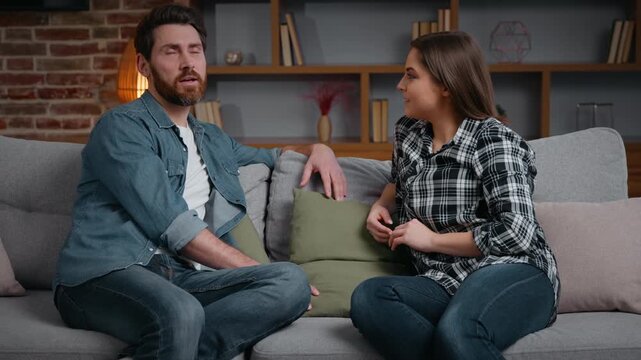 Caucasian couple in love friends man woman talking on couch at home marriage partners husband and wife girlfriend with boyfriend communicate pleasant conversation carefree happy talk on sofa together