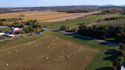 Peaceful farmland in Autumn Fall season with red barn and silos beside countryside road with rolling hills up state New York, Fairport © Steve Tanner Stock