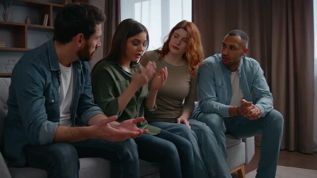 Four multiethnic friends supporting stressed woman sharing bad news at home party on couch problem grief girl talking trouble multiracial women men consoling hugging cuddling helping listening empathy