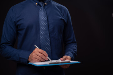 Businessman Writing on Document with Pen and Clipboard in Office Setting