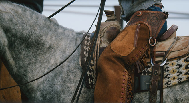 Cowgirl on horse for ranch work, western industry background.