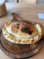 Freshly Baked Calzone on Wooden Board