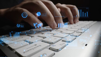 A close-up shot of hands typing on a keyboard, enhanced with a digital overlay of analytics graphs and statistics, symbolizing the fusion of technology and data in today workspace. Xenic