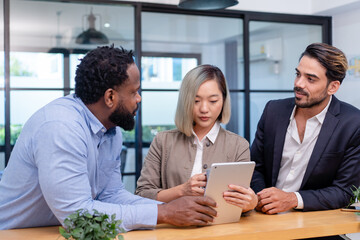 team of multiethnic colleague discuss business topic in creative green office co working space, group of business people coworker casual online meeting on laptop standing desk modern office workplace