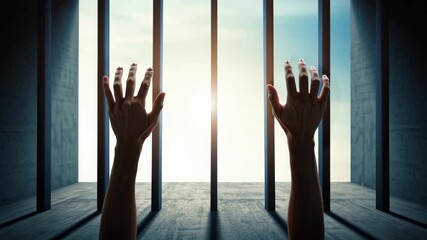 Hands Reaching Through Bars Towards Light Symbolize Hope and Freedom in Struggle Against National Slavery and Human Trafficking Prevention Month