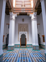 Intricately Designed Moroccan Riad Courtyard Showcasing Vibrant Mosaic Tiles, Elegant Carved Plasterwork, and Traditional Wooden Architecture in Marrakech