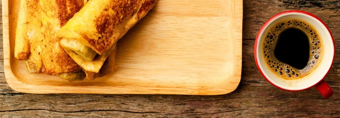 Golden french toast sticks with a cup of black coffee