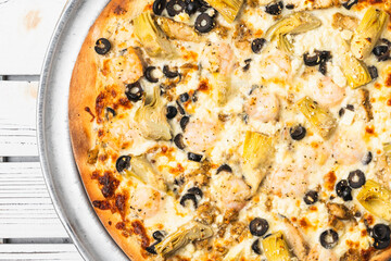 Mediterranean pizza with shrimp and artichokes