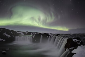 Northern Lights or Aurora Borealis, river Skjálfandafljót, waterfall Góðafoss or Godafoss, long exposure, North Iceland, Iceland