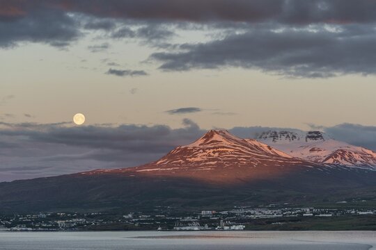 Mountain landscape with moonrise behind Akureyri, Iceland's second largest city, Eyjafj&ouml;r&eth;ur, Iceland