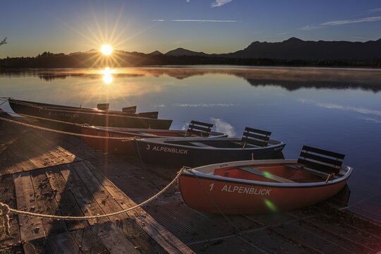 Rowing boats, sunrise, lake, mountains reflected in water, Staffelsee, Murnau, foothills of the Alps, Bavaria, Germany