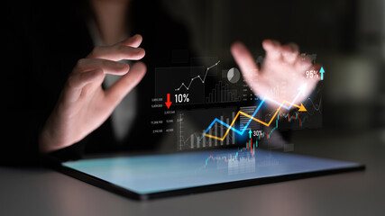 A business professional interacts with digital financial graphs on a tablet, emphasizing modern data analysis and trends within a contemporary workspace. Scalp
