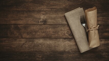Old tableware wrapped in paper on sackcloth napkin on wooden background background,food,paper,vintage,table,retro,restaurant,grunge,cooking,breakfast