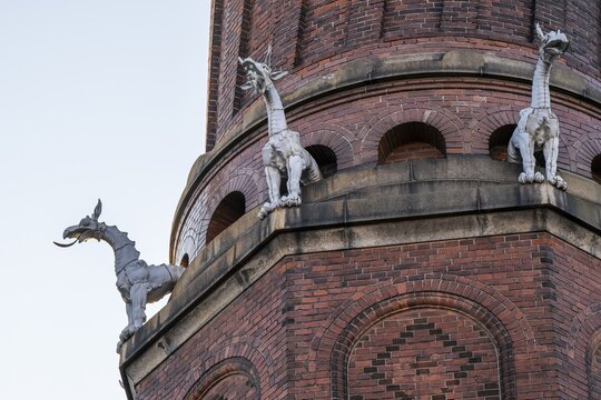 Detail of coiled industrial chimney by Carl Jacobsen, Vilhelm Dahlerup and PS Beckmann with replicas of the chimeras or gargoyle sculptures from Notre-Dame, Carlsberg district, Copenhagen, Denmark