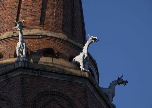 Detail of coiled industrial chimney by Carl Jacobsen, Vilhelm Dahlerup and PS Beckmann with replicas of the chimeras or gargoyle sculptures from Notre-Dame, Carlsberg district, Copenhagen, Denmark