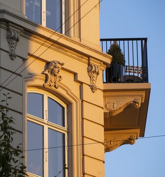 A building in warm evening light with decorative fa&ccedil;ade elements and balcony, Frederiksberg, Copenhagen, Denmark