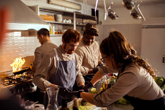 Chefs preparing food in restaurant kitchen