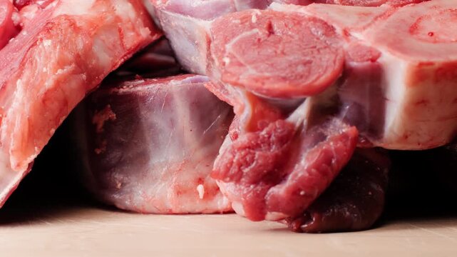 Fresh beef ossobuco steak with salt, spices and herbs on textured background, bones. 
