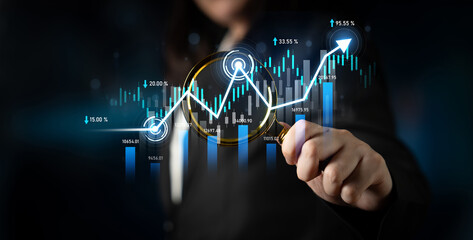A business professional examines data trends with a magnifying glass, highlighting growth in a...