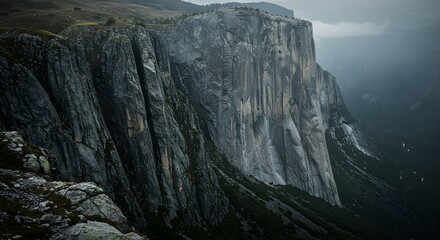The sheer vertical drop of a mountain cliff.
