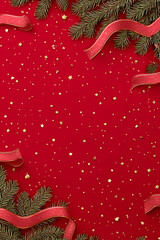 Red festive Christmas background with shiny baubles, pine branches, and glitter decorations creating a joyful holiday atmosphere