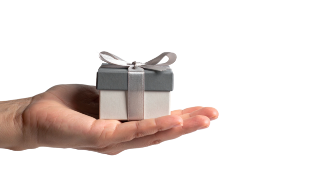 A hand holds a beautifully wrapped gift box with a ribbon on top. The box is presented, conveying the act of giving. 