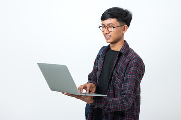 Smiling college student using laptop on white background
