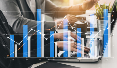 A professional business team collaborates on data analysis using graphs and charts displayed on a...