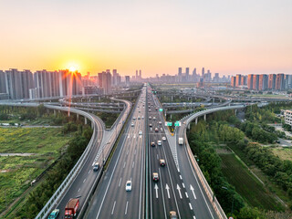 Fototapeta premium Aerial views of urban highways and interchanges at sunrise