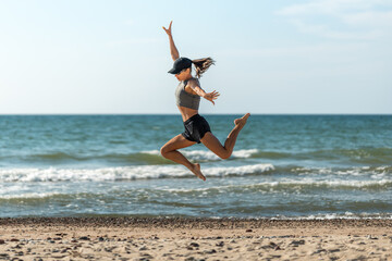 Energetic woman leaps at beach, Woman swiftly sprints and soars on sand, Woman rapidly runs and vaults with joy © Alex Unders