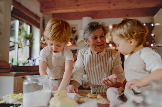Family holiday baking with grandma in cozy kitchen.