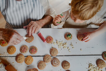 Christmas baking tradition with grandma and little kid.