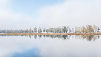 Autumn river in a foggy morning. Farnebofjarden national park in north of Sweden.
