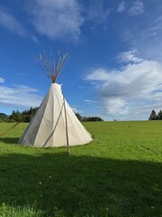 Teepee is standing in a grassy field © flucas