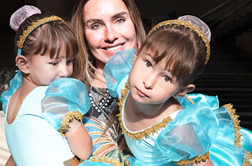 Beautiful mother with twin daughters dressed as ballerinas. Brasilia, Brazil, October 202