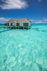 Top Luxury Maldives Water Villas over the Gorgeous Turquoise Ocean Lagoon. Best Sunny Tropical Nature Scene creates the Perfect Summer Holiday Tourism Background Exclusive Popular Vacation Destination