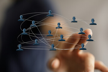 Concept of communication, digital networking, teamwork, and global connections depicted with a hand touching a 3D interface network.