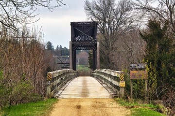 Cloudy early Summer landscape featuring an old trestle converted for recreational use along the Red Cedar State Trail near Caryville, Wisconsin.