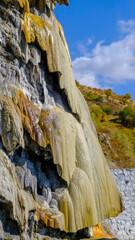 travertine waterfall wide angel shot, with mineral waters, the waterfall turned into chalky and colorful travertines.